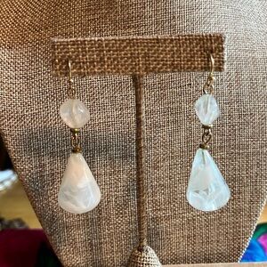 Gold tone drop earrings with clear/white swirl beads